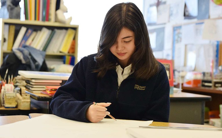 Young girl studying in library