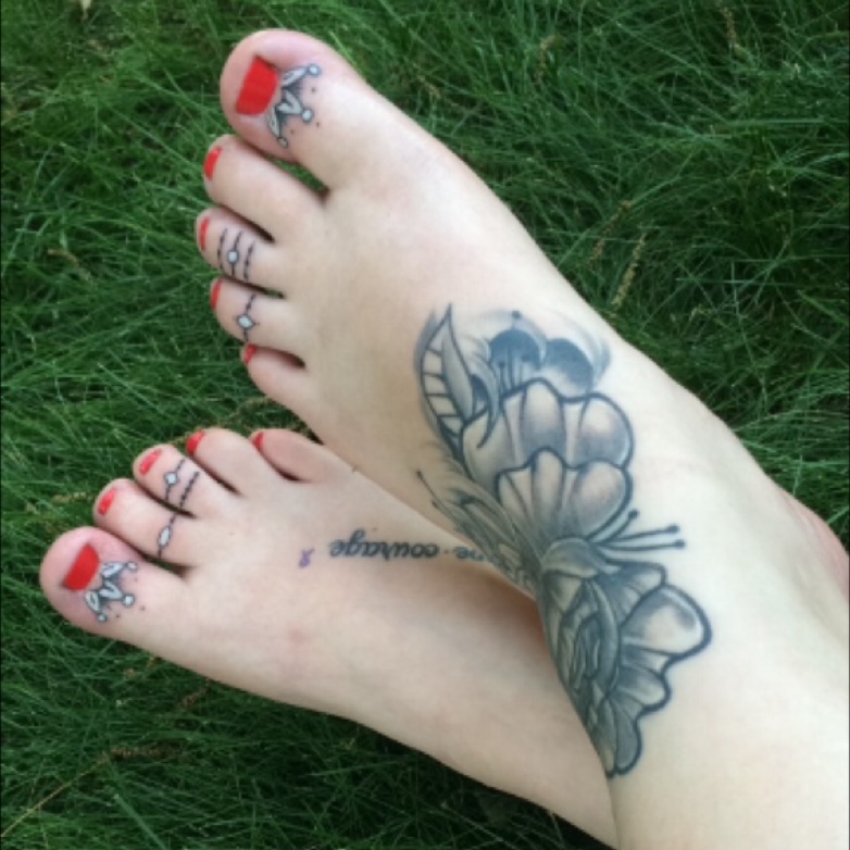 Smiley tattoo on the thumb toe