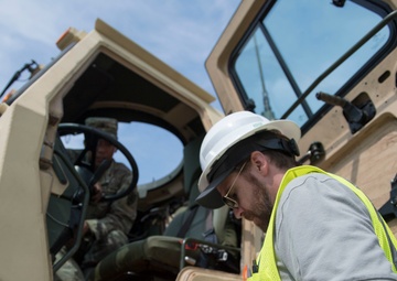 Soldiers unload cargo of knowledge to local dockworkers