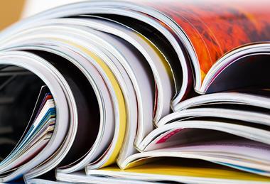 Closeup of a pile of magazines with bending pages