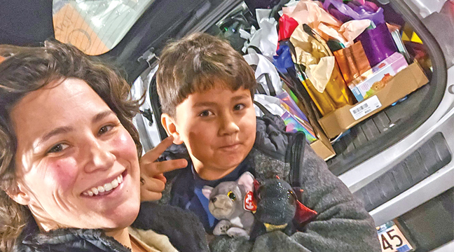 TAYLa LIST (L) and her son, Ezekiel with the back end of their vehicle packed with care packages to be delivered to the Mayo Clinic in Rochester. (Submitted Photo).