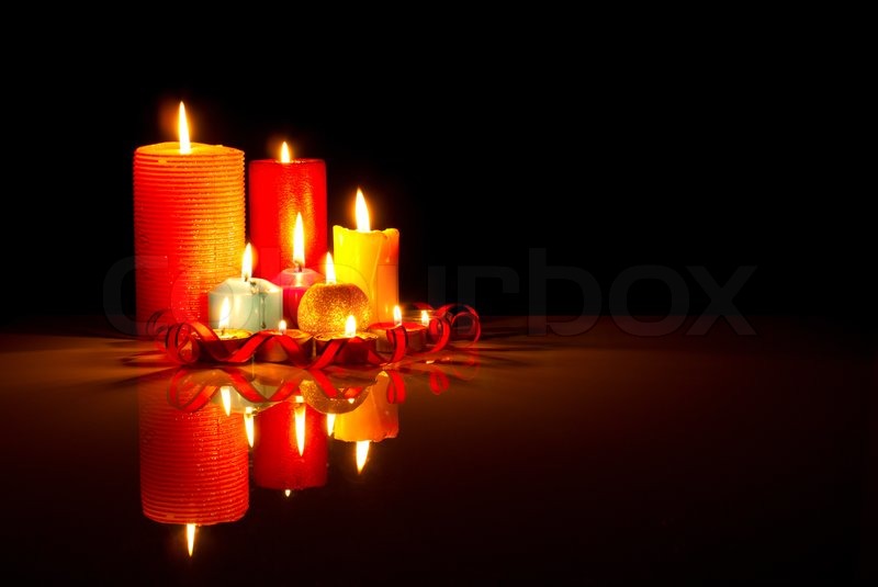 A lot of burning colorful candles against black background | Stock image |  Colourbox