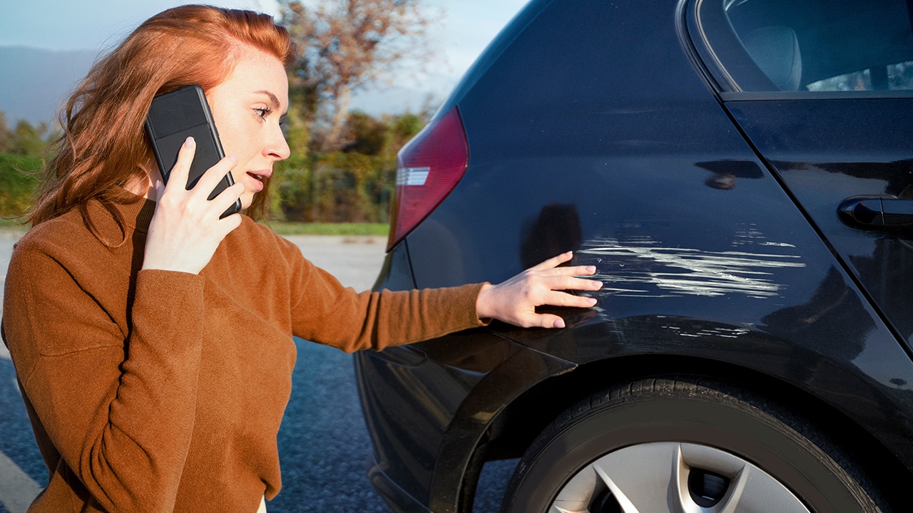 Woman reporting car accident event calling on the phone