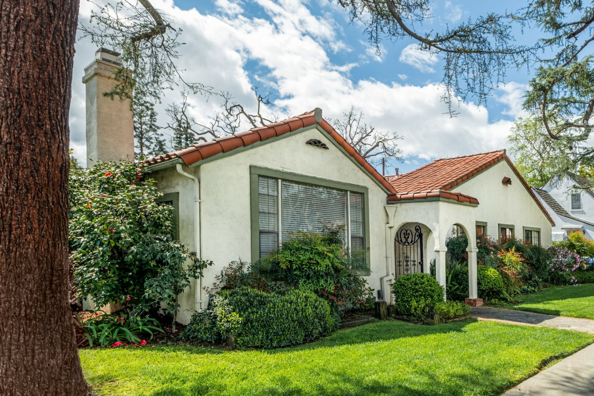 A Spanish style house in California with a green yard.