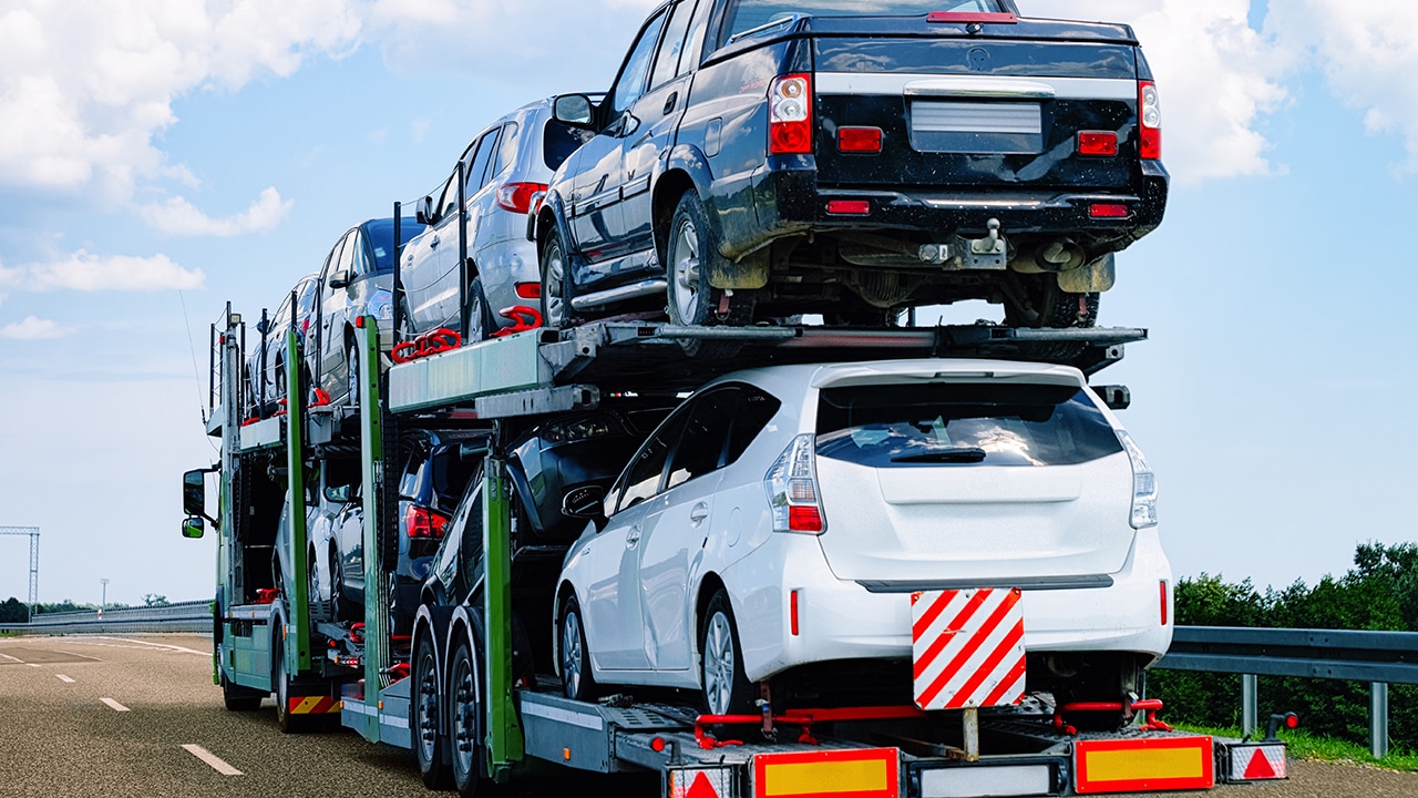 Cars carrier at the road. Truck transporter