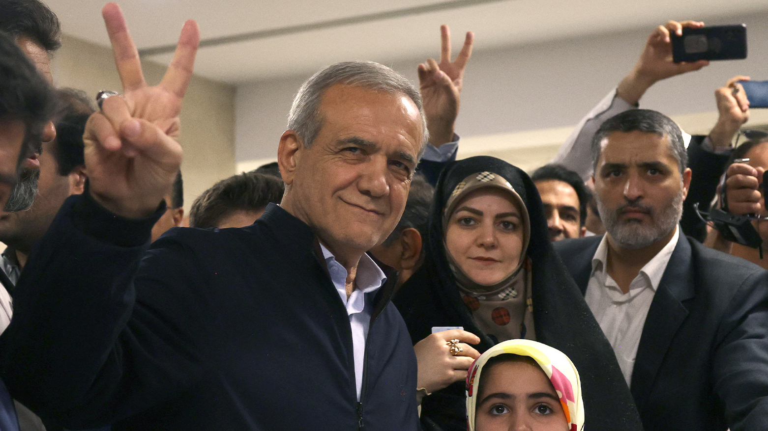 Iranian presidential candidate and reformist Masoud Pezeshkian, flashes the V-sign for victory after casting his vote during the presidential election in Tehran on June 28, 2024. (Photo: AFP)