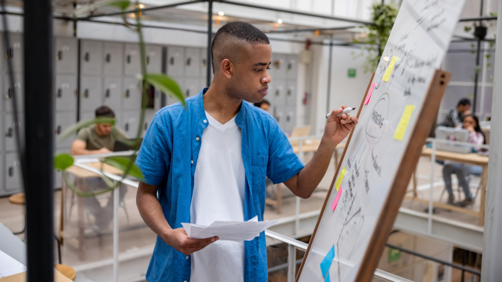 Male young entrepreneur points to a business plan