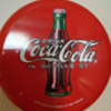 12" round coca cola button sign. Can anyone tell me anything about it? I was told it's from 1930-1940 pristine condition