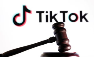 Illustration shows Tik Tok logo and a judge gavel