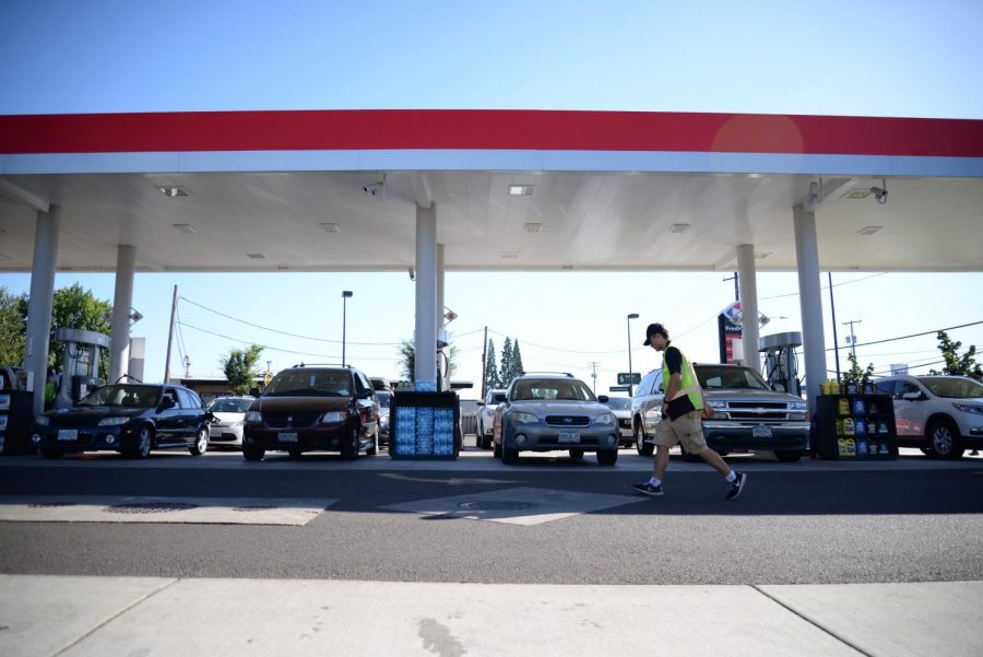 A Fred Meyer gas station attendant works to keep up with motorists on Aug. 18, 2017. Oregon's decades-long ban on self-serve gas was lifted by the passage of House Bill 2426.