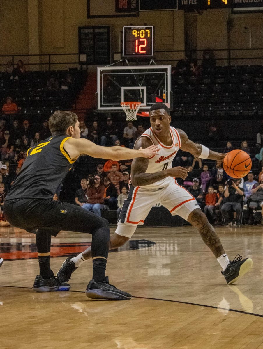 Guard Damarco Minor (0) dribbles down the court to make the next shot at the home game in Gill Coliseum Dec. 7.