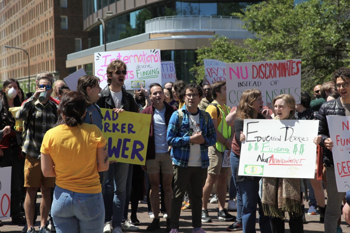 NUGW union members gathered outside of Rebecca Crown Center to deliver an open letter to University administration calling for adequate funding resources for graduate students.