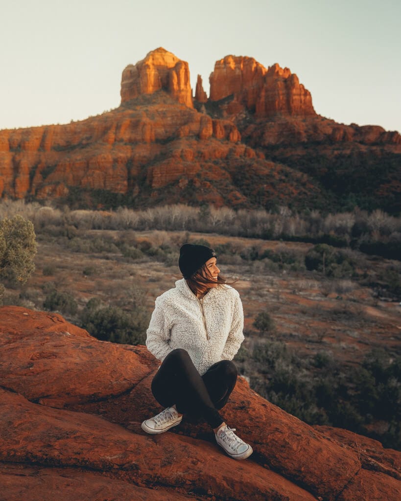 female hiker enjoying a vibrant red sunset on secret slickrock trail in sedona arizona