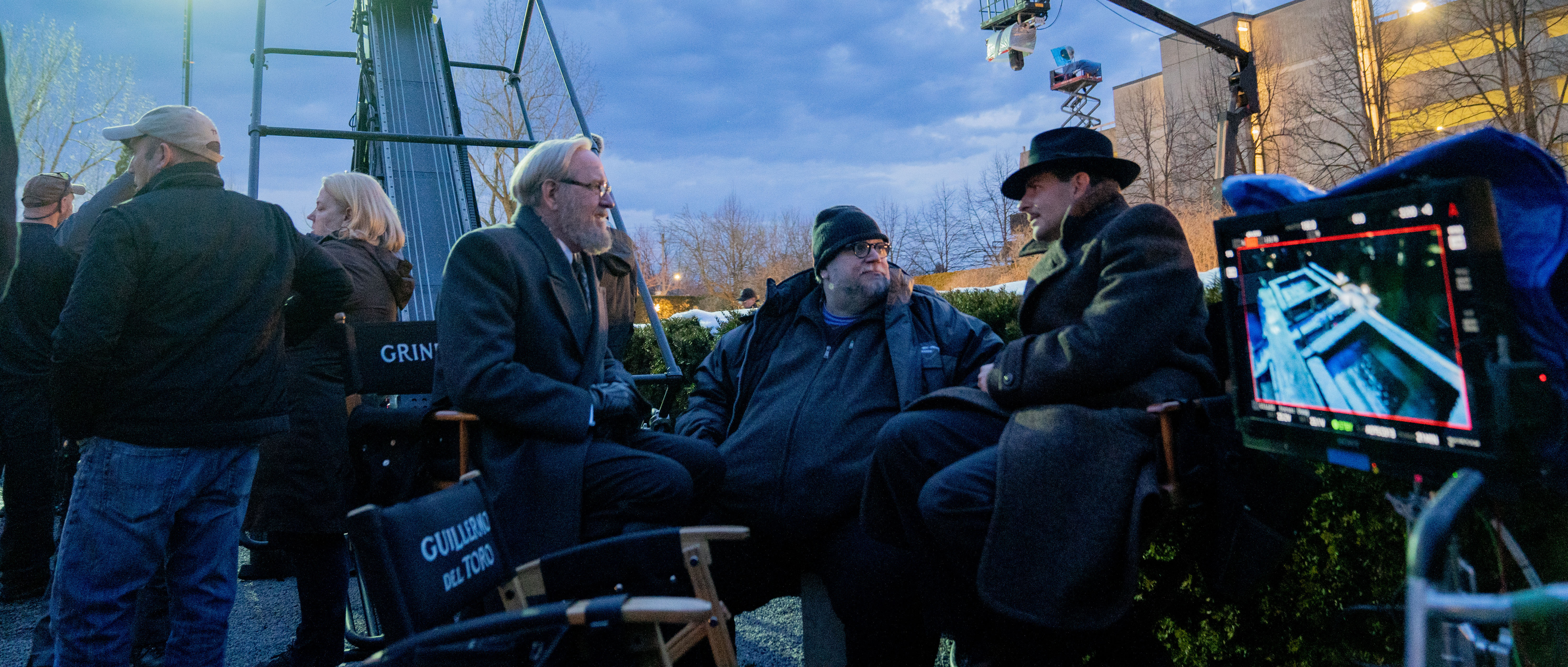 Richard Jenkins, Guillermo del Toro and Bradley Cooper on the set of Nightmare Alley