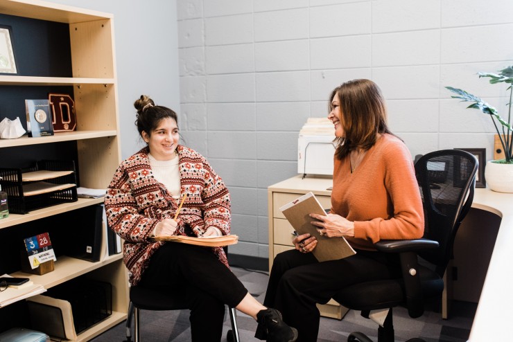 A career and success advisor mentoring a student in the advising center