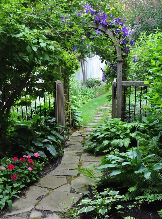 I think all gardens should have some sort of pathway. This is beautiful! Flagstone walkway and arbor.: 