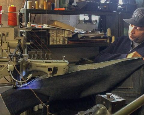 Denim designer Maurice Malone, owner of Williamsburg Garment Company, sewing a pair of jeans with a Union Special 35800 industrial sewing machin in the tapering alterations process.