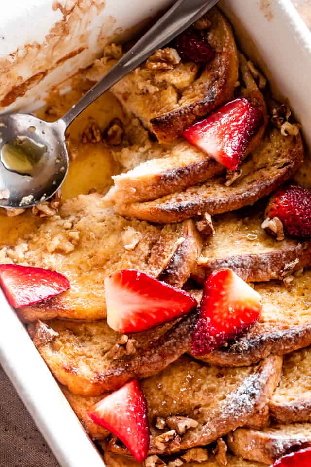 Breakfast casserole with powdered sugar and sliced strawberries. 