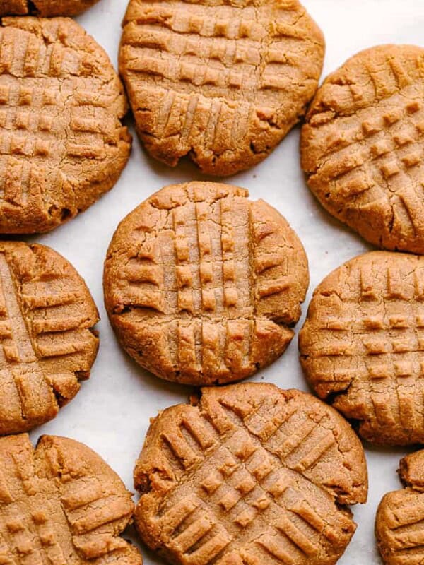 Peanut butter cookies on a parchment-lined baking sheet.