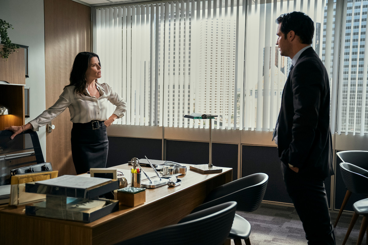 Neve Campbell as Maggie McPherson, Manuel Garcia-Rulfo as Mickey Haller in The Lincoln Lawyer Season 1.