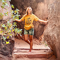 A photograph of Gabby Petito posing on a trail. 