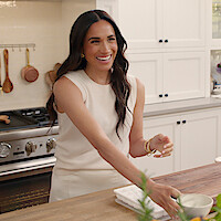 Meghan laughing in the kitchen. 