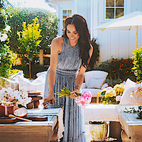 Meghan cuts a bouquet of flowers outside.