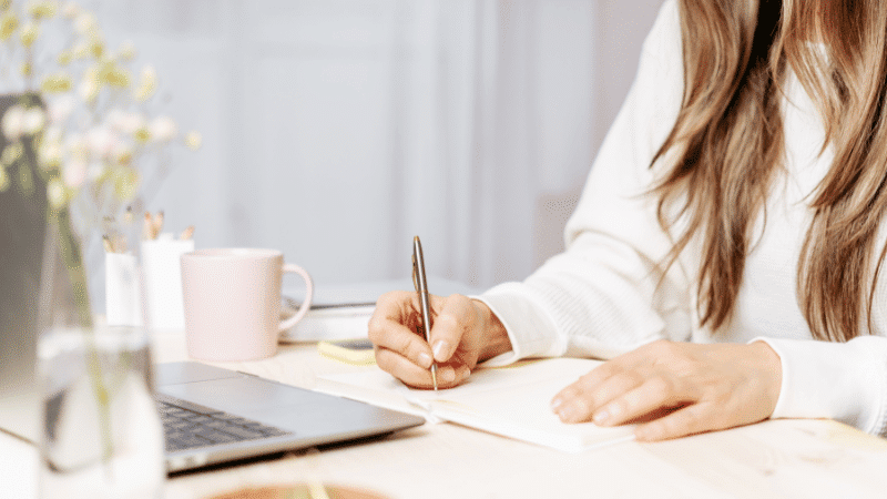 Image of a person writing a donation request letter