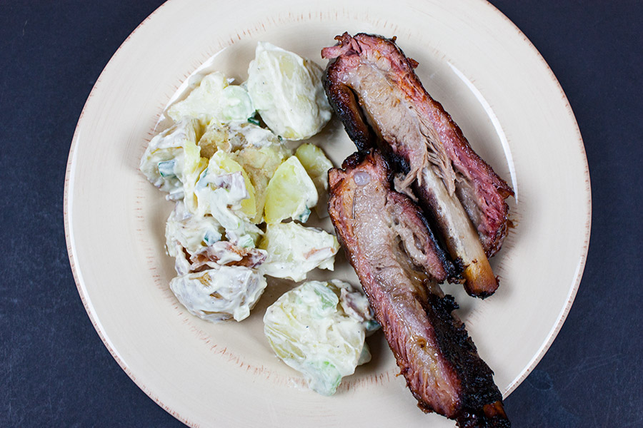 St Louis Style Ribs on a plate with potato salad.