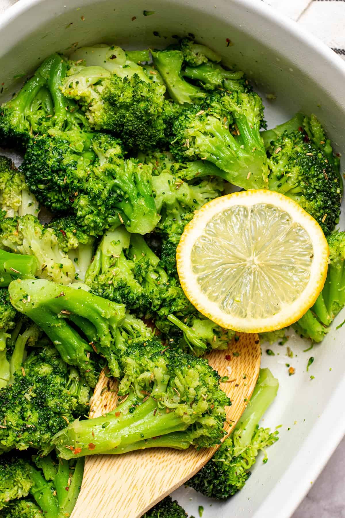 Air Fryer Frozen Broccoli in a baking dish with a slice of lemon