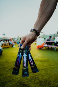 A person holding three sticks in their hand.