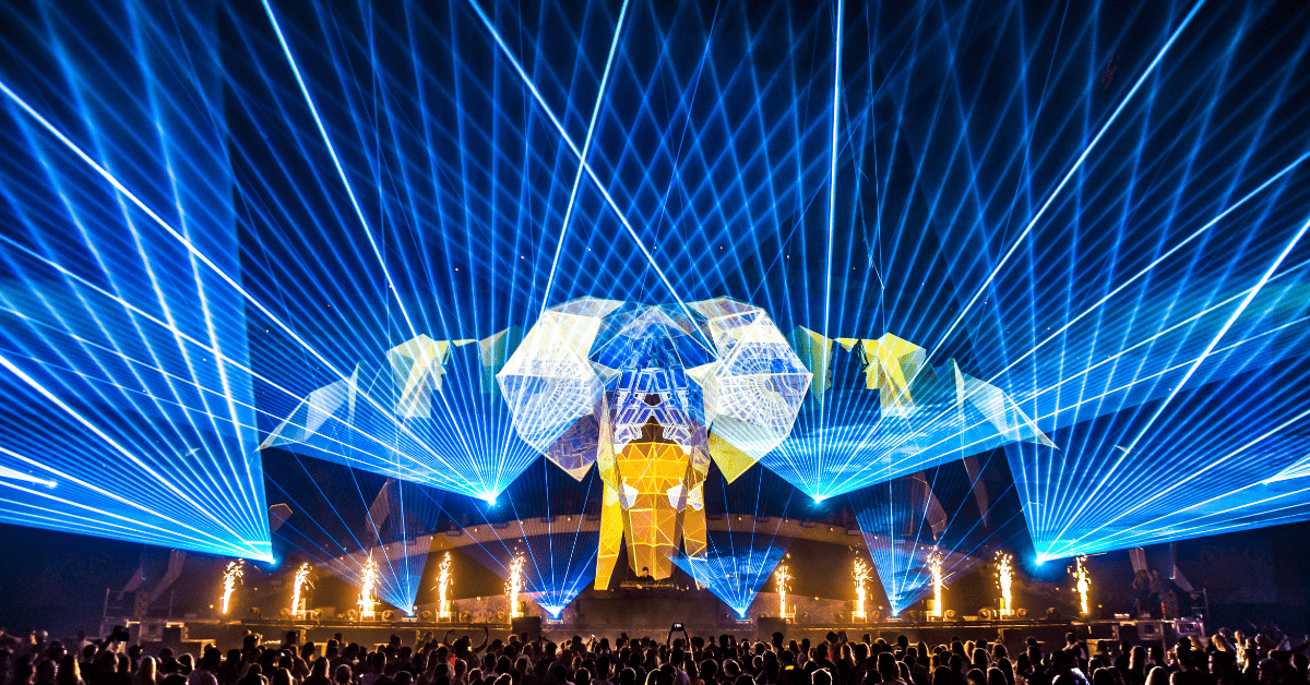 A crowd of people standing in front of a stage.