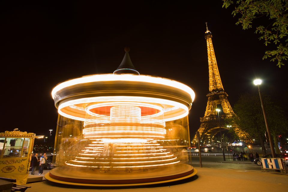 Spinning Carousel and Eiffel Tower at Night