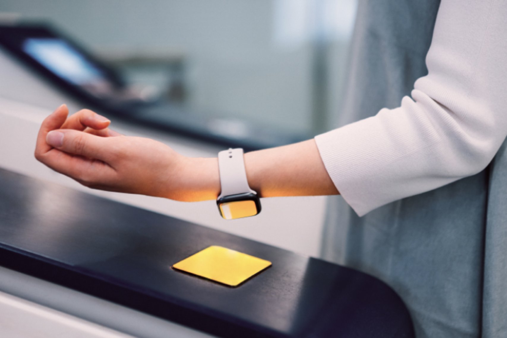 A person using a smartwatch to pay