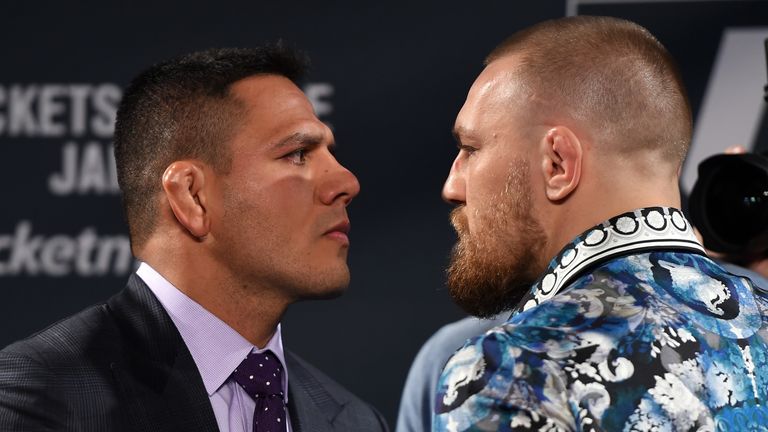 Rafael dos Anjos of Brazil (L) and Conor McGregor of Ireland (R)