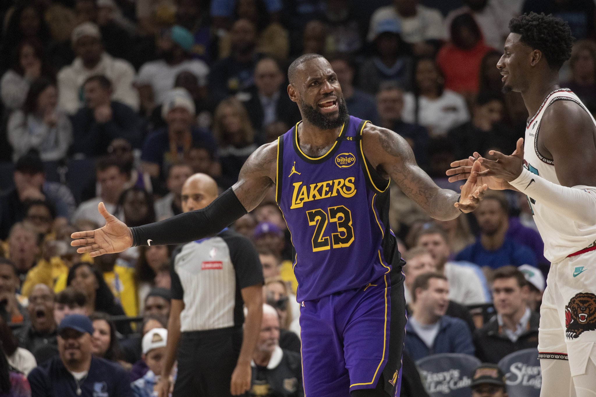 Los Angeles Lakers forward LeBron James (23) talks with the referee as Memphis Grizzlies forward Jaren Jackson Jr. (13) looks