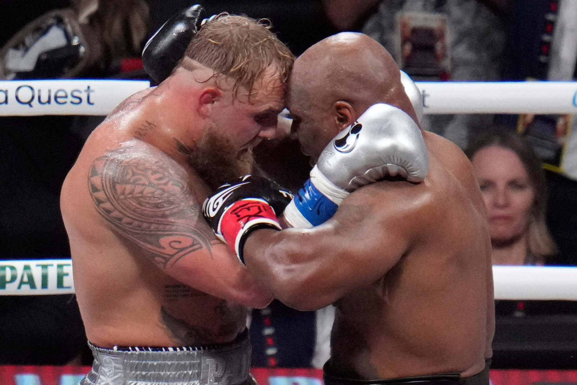 Jake Paul and Mike Tyson embrace each other after their fight.