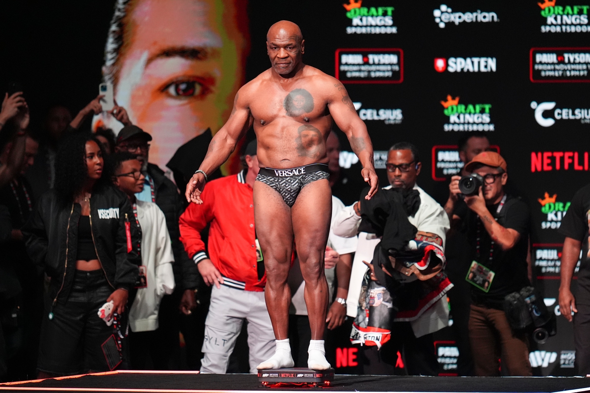 Mike Tyson steps on the scale during a weigh-in ahead of the fight against Jake Paul.