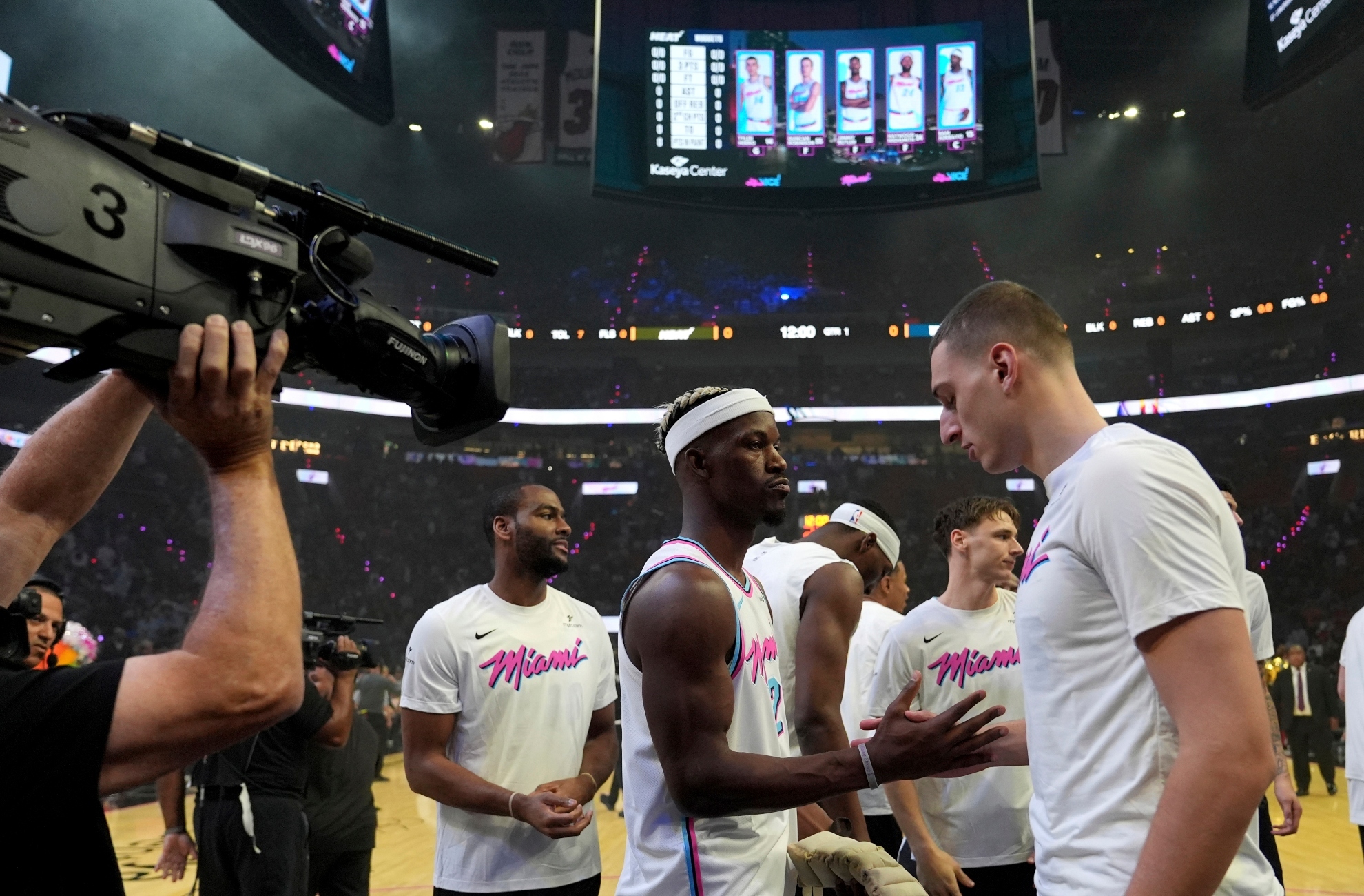 Miami Heat forward Jimmy Butler, second from left, shakes hands with forward Nikola Jovic, right, before an NBA basketball game against the Denver Nuggets, Friday, Jan. 17, 2025, in Miami.