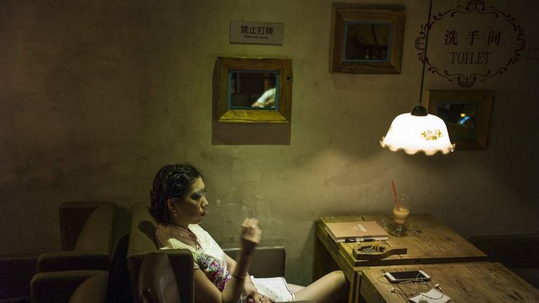 A woman smoking a cigarette in a bar in Beijing