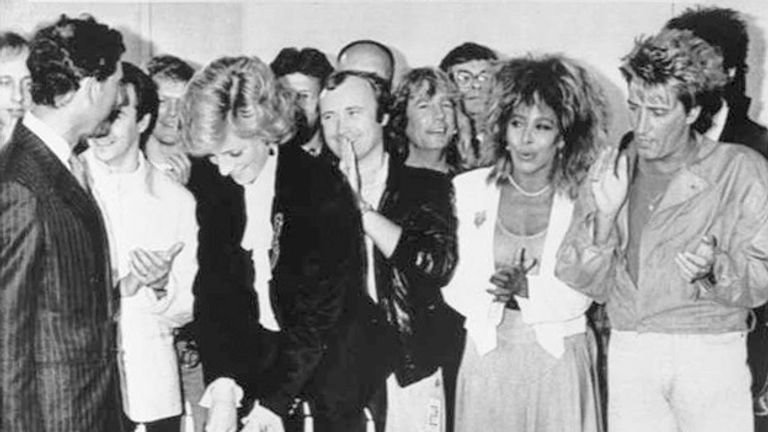 June 1986: Prince Charles and pop stars look on as Princess Diana cuts a cake to mark the tenth year of the Prince's Trust at a charity rock concert at Wembley 