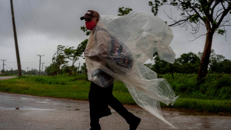 A man battles strong winds and rain as Hurricane Ida crossed Cuba earlier this week Pic: AP 