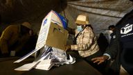 Electoral workers empties the ballot box during the counting at Itireleng informal settlement in Pretoria, South Africa, Wednesday, May 29, 2024, during the general elections. AP Photo/Themba Hadebe)