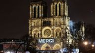 The word 'merci' was projected onto the front of the cathedral. Pic: AP