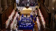 Clergy members and singers of the choir of the Maitrise de Notre-Dame sit in the nave during an inaugural Mass, with the consecration of the high altar, at the Notre-Dame de Paris Cathedral, five-and-a-half years after a fire ravaged the Gothic masterpiece, as part of ceremonies to mark the Cathedral's reopening after its restoration, in Paris, France, Sunday, Dec. 8, 2024. (Sarah Meyssonnier/Pool Photo via AP)