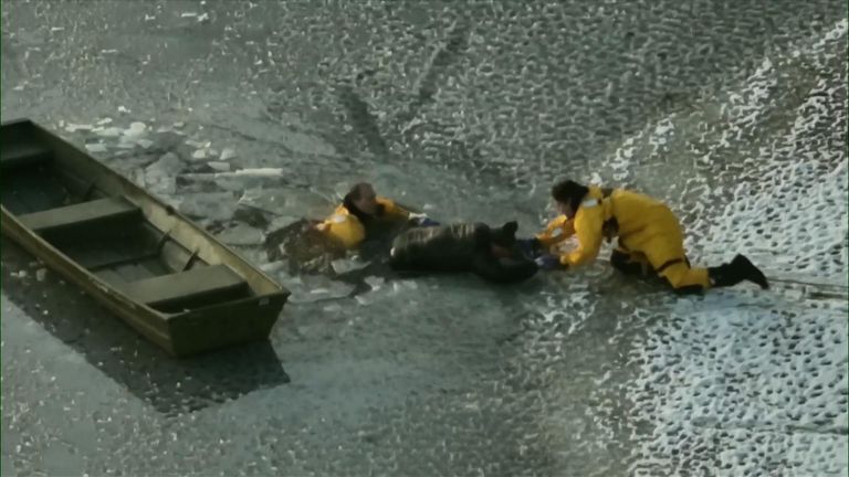 Firefighters rescued a man and his dog who had gotten stuck in an icy lake in Massachusetts. 