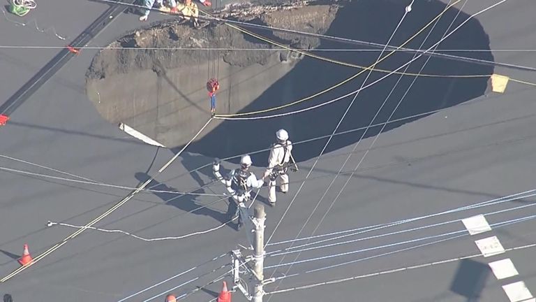 A swimming pool sized sinkhole opened up on a busy street in Japan, swallowing a truck and trapping the driver. 