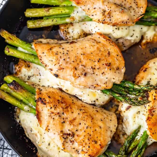 Cheesy Asparagus Stuffed Chicken Breast is the BEST Stuffed Chicken Recipe we have ever made! Tender chicken loaded with two types of cheese (goat cheese and mozzarella) and asparagus just can't be beat. The flavor is out of this world! Chicken and Asparagus for the win.