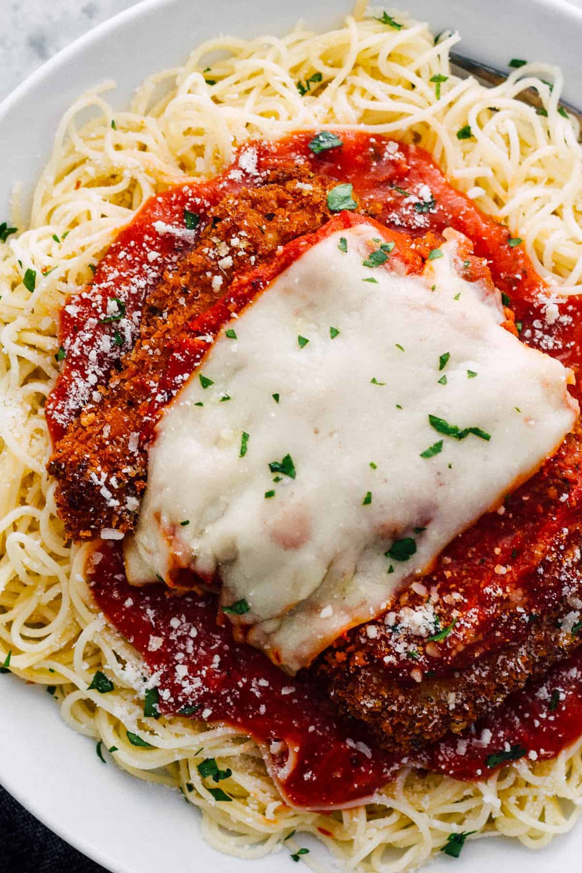 easy chicken parmesan over sauce and pasta