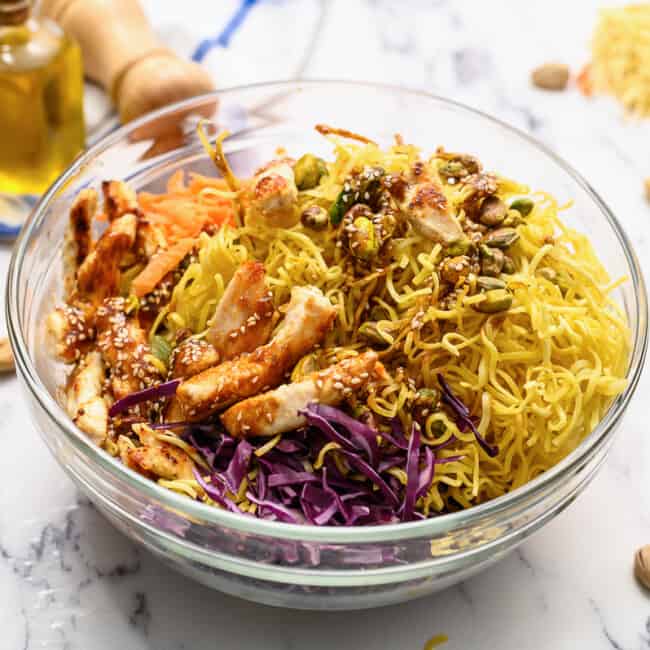 A Chinese chicken salad recipe featuring a bowl of noodles with vegetables.